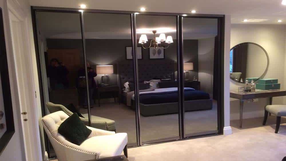 Smoked glass fitted wardrobe by Glide & Slide